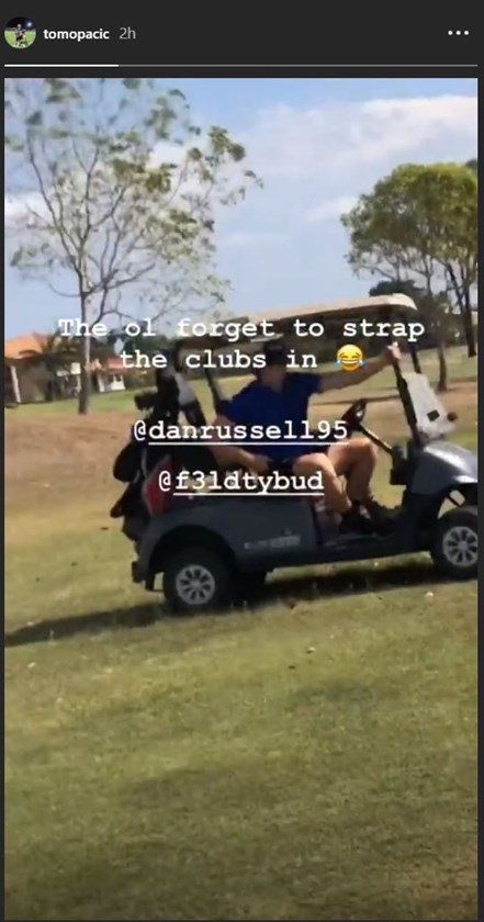 Dan Russell and Kyle Feldt lose their clubs off the back of the golf buggy